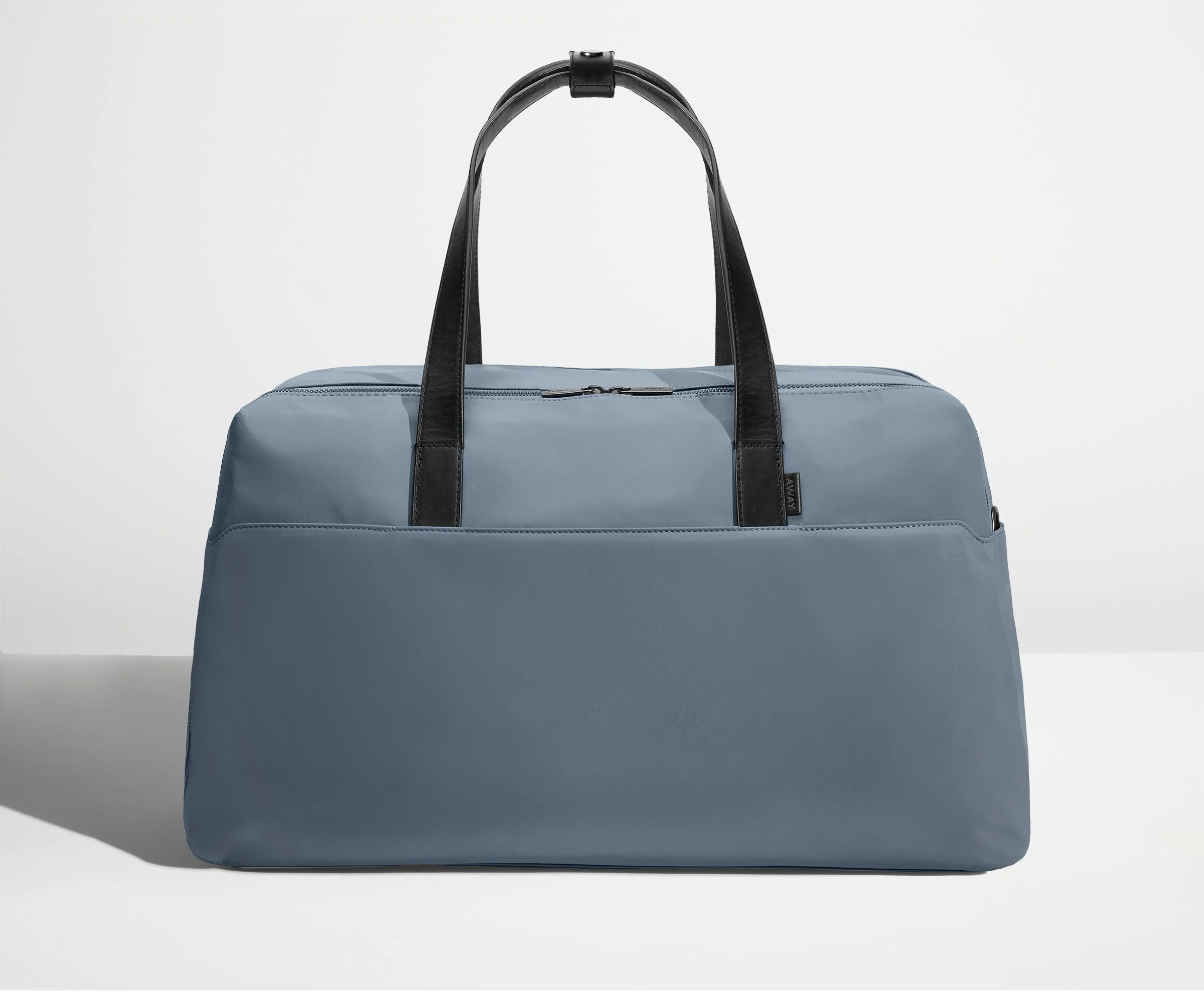 Front view of Away's Weekender duffle in Coast Blue with handles up