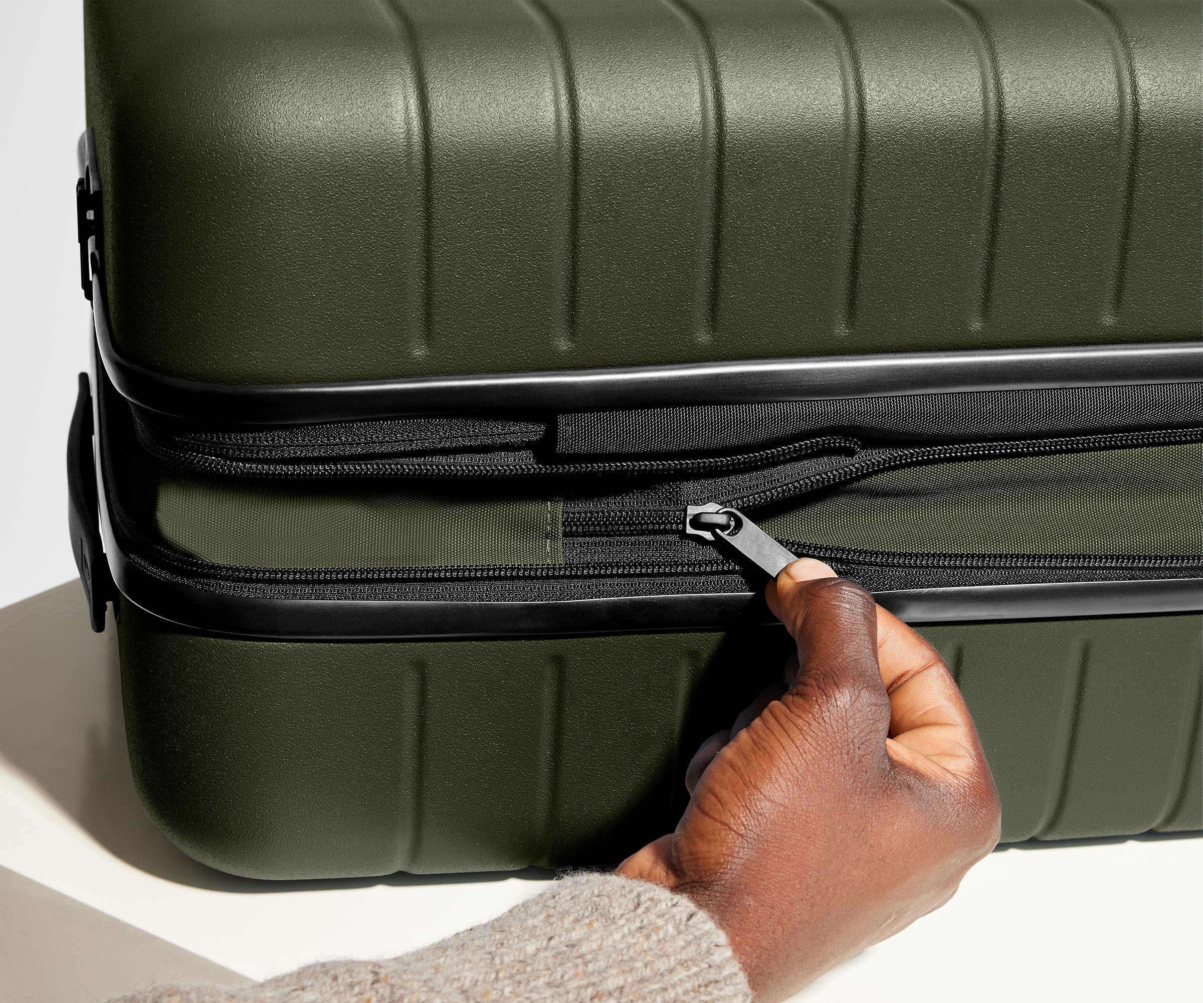 Hand unzipping the additional wraparound expansion feature