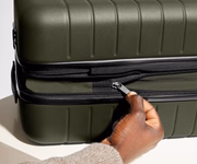 The Bigger Carry-On Flex suitcase in Olive Green has an additional wraparound zipper to expand the suitcase 2.25" (6 cm) and increase packing space