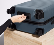 The Bigger Carry-On suitcase in Coast Blue shown from below highlighting the underside grab handle