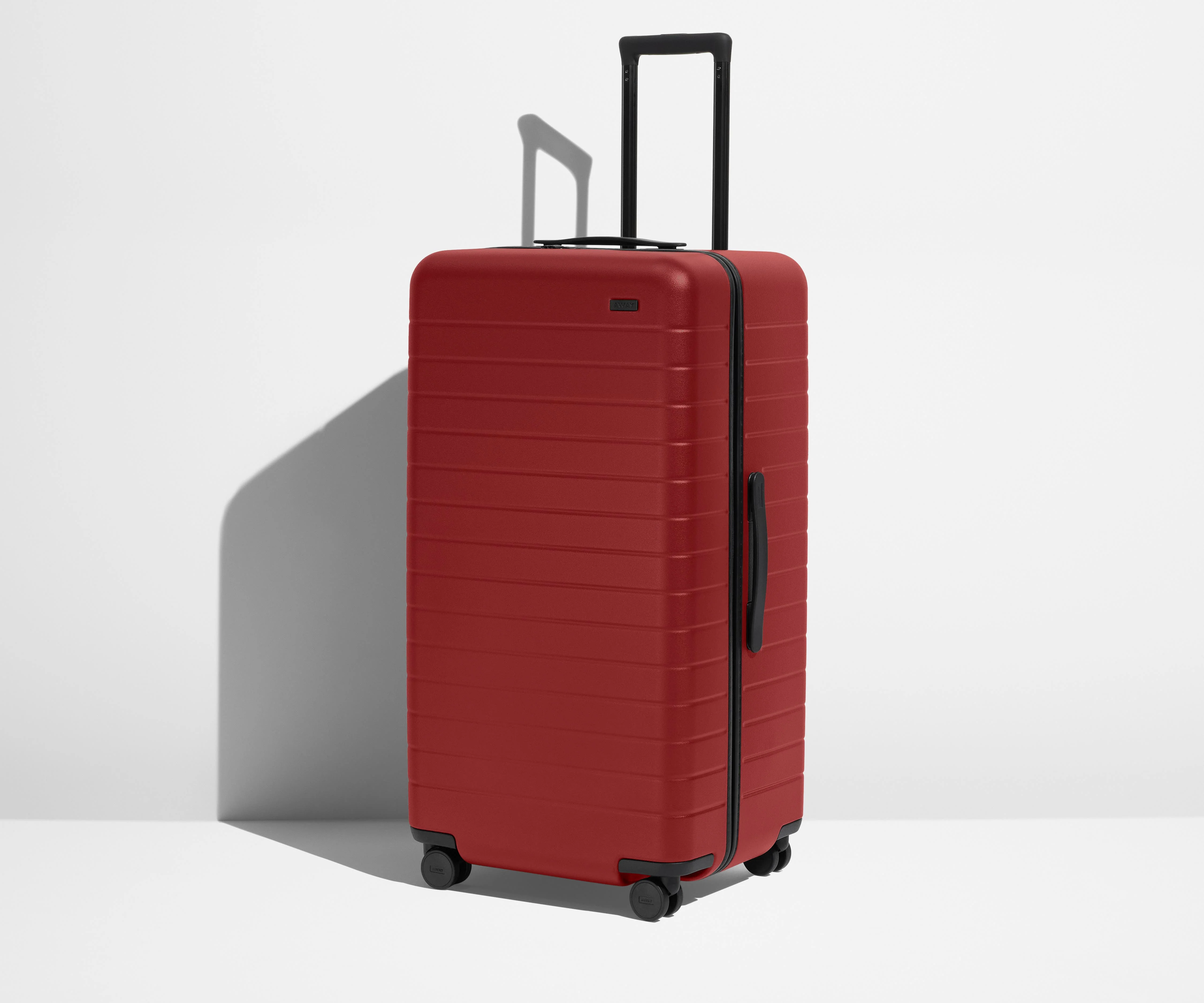 Angled product view of The Trunk suitcase in Tango Red
