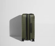 Side product view of The Bigger Carry-On Flex suitcase in Olive Green shown fully expanded