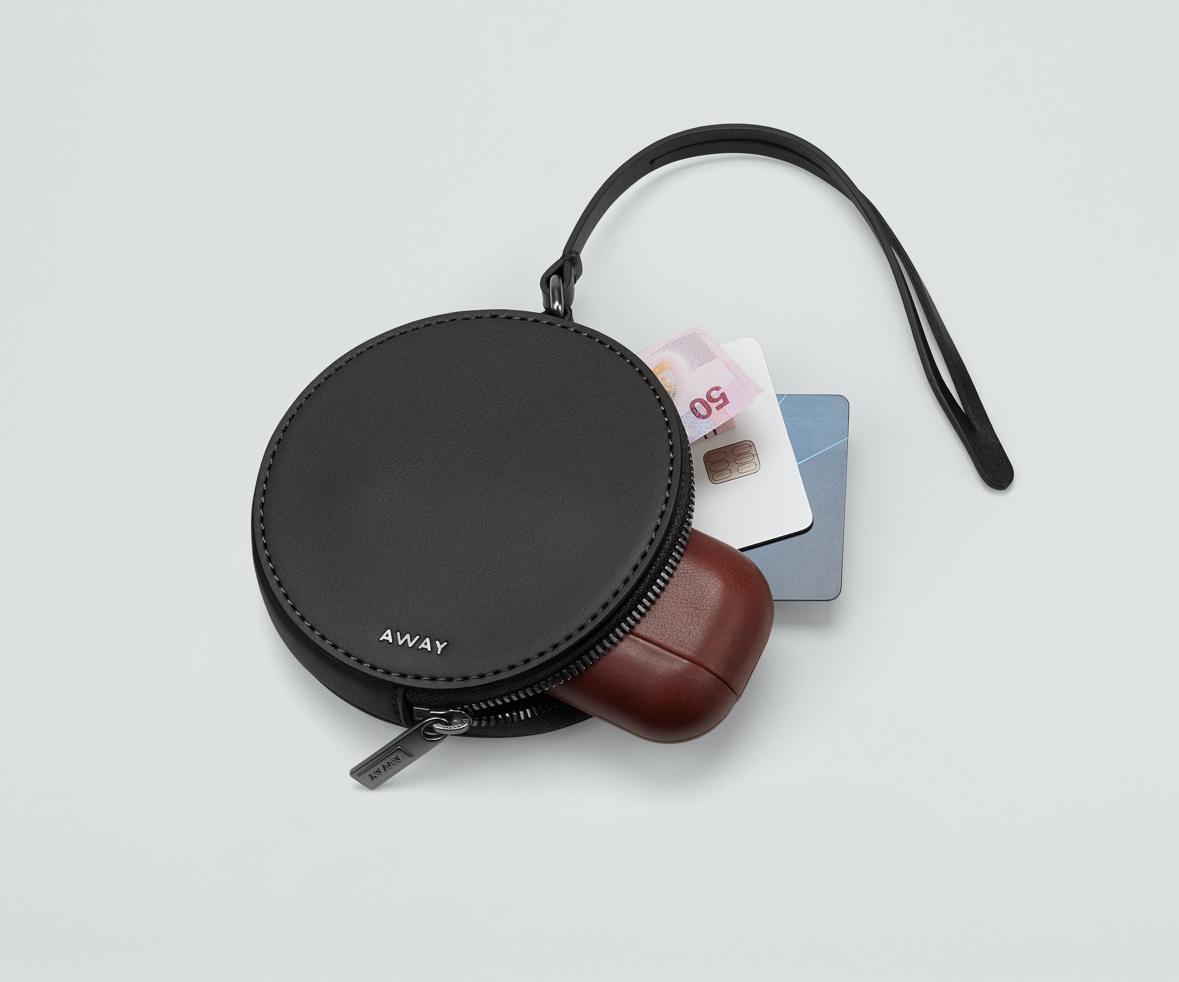 Circle Zip Pouch packed with earpods, credit cards, and money