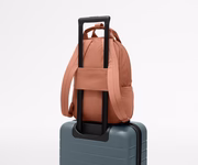 Featherlight Backpack on top of an Away suitcase, attached by the trolley sleeve