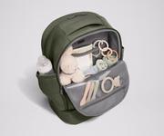 Front main compartment packed with child essentials, including a stuffed animal, wipes, and change of clothes