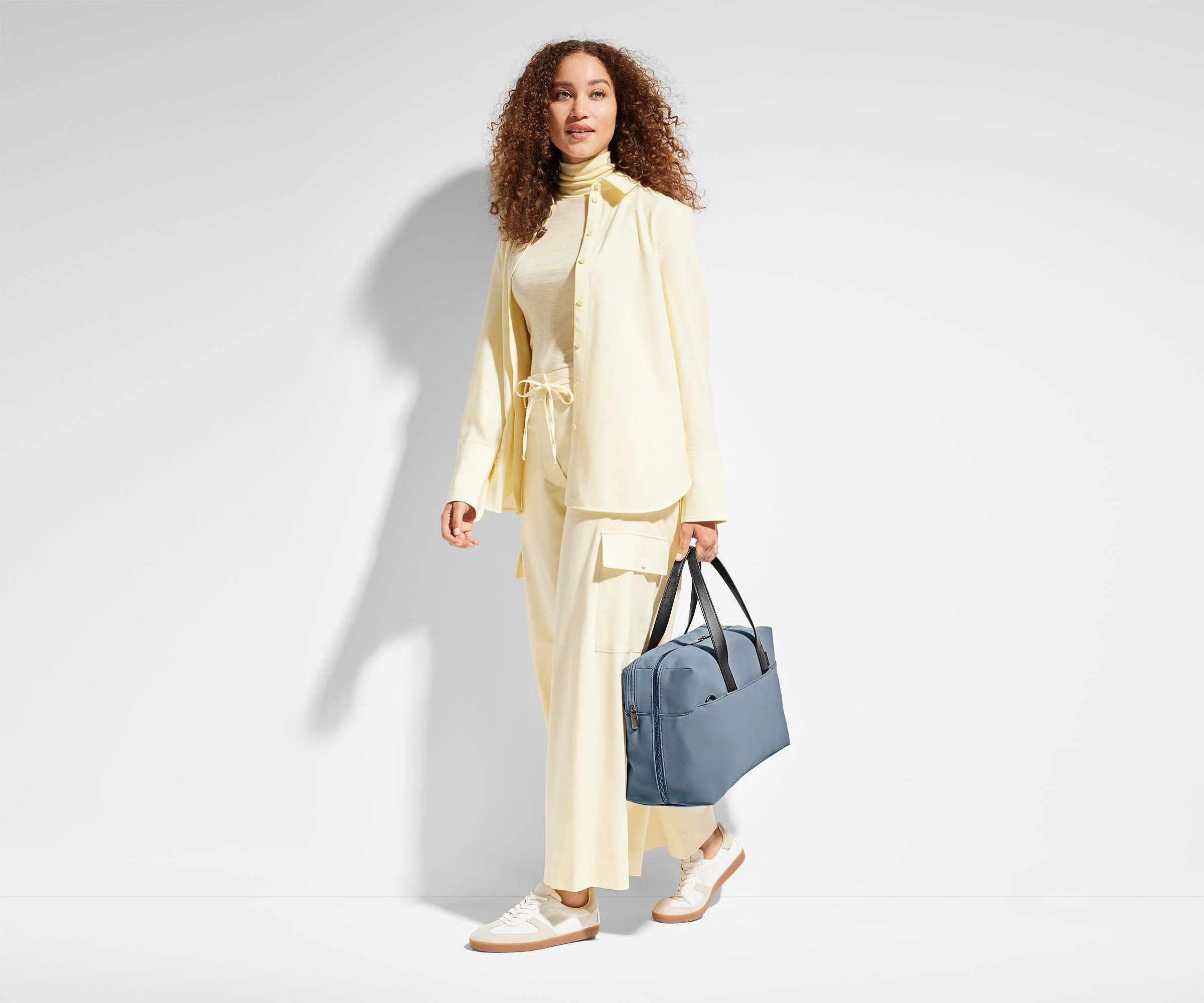 Person holding the Everywhere Bag by its leather straps