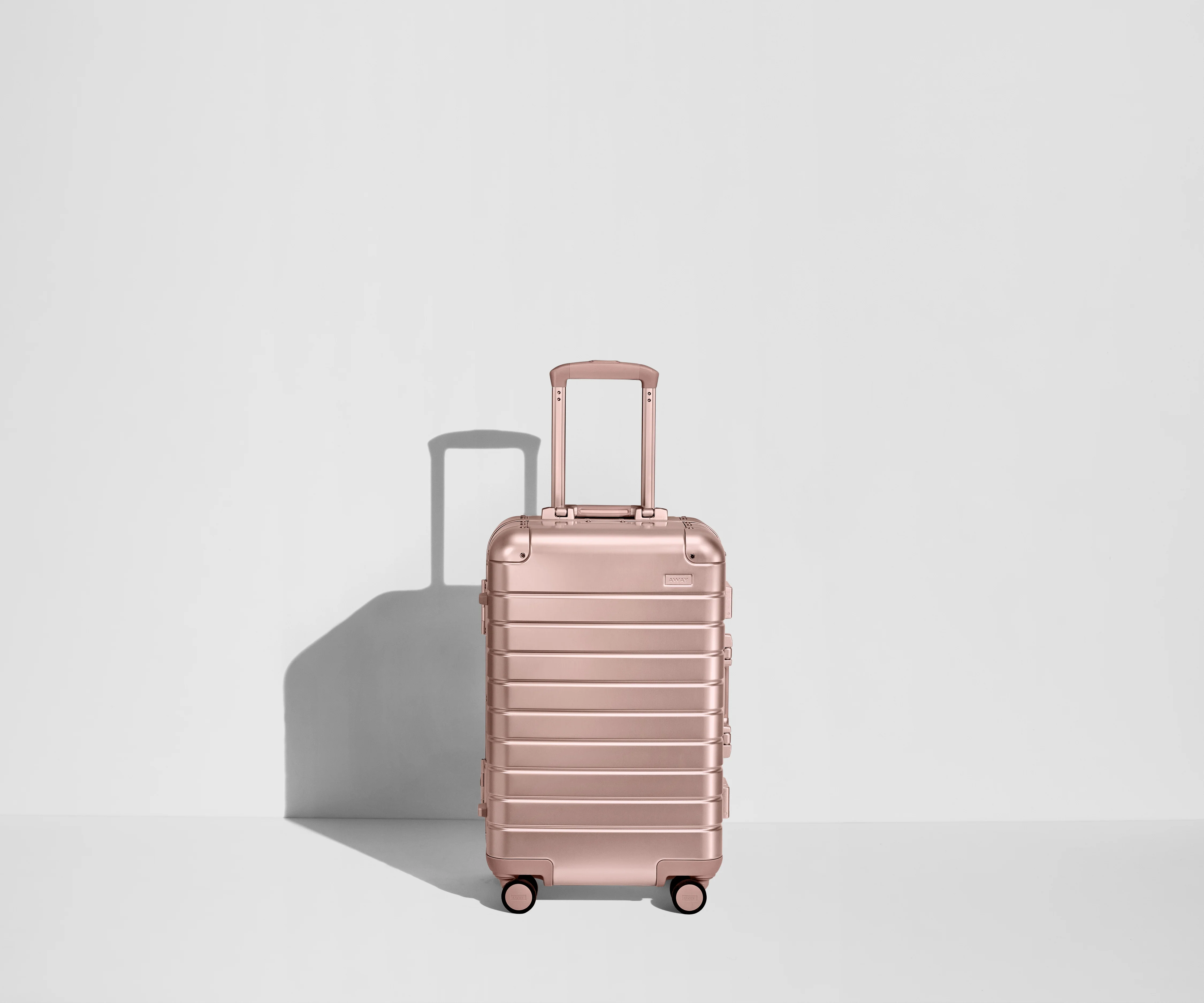 Front view of a Bigger Carry-On: Aluminum Edition suitcase with handles raised