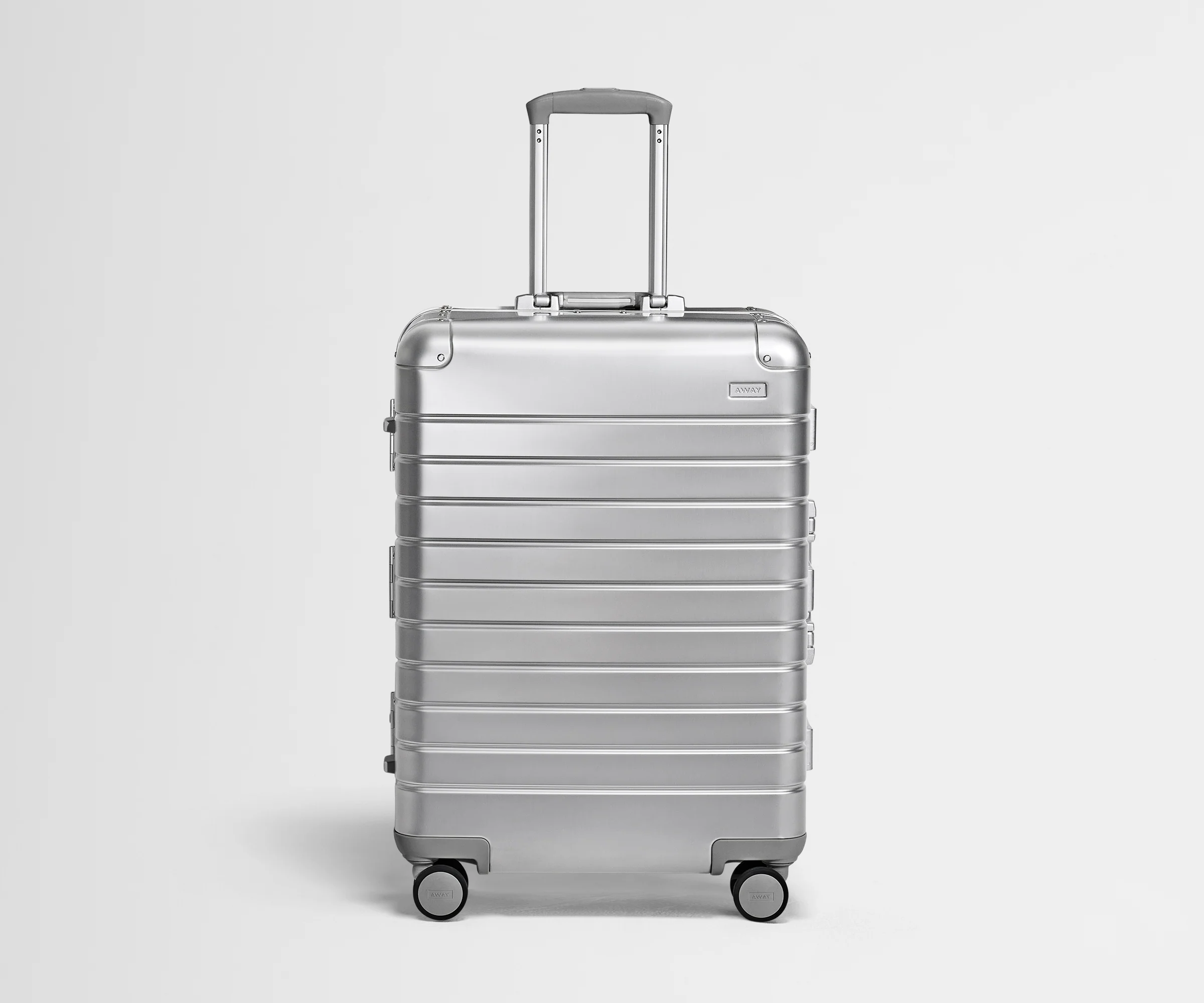Front view of the Medium: Aluminum suitcase in Silver with handles raised
