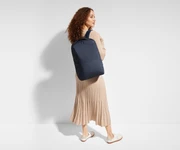 5'9" person wearing a Navy Blue Everywhere Zip Backpack on one shoulder