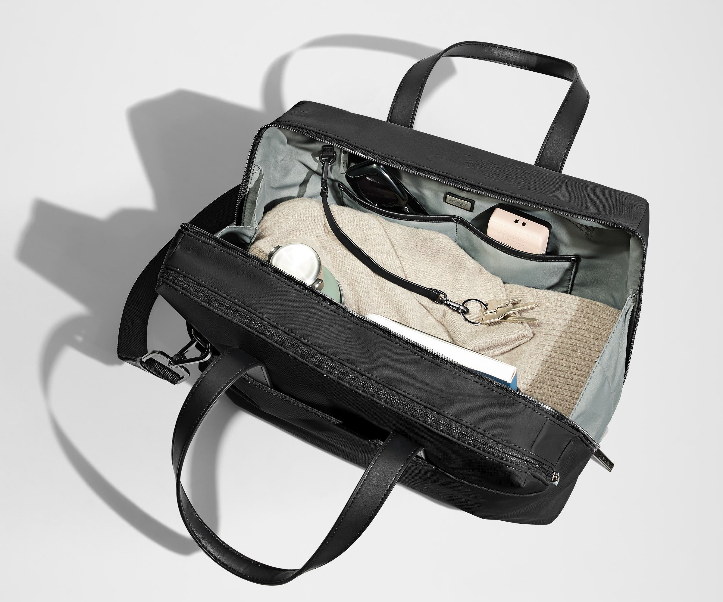A pair of keys attached to the key leash in the main compartment