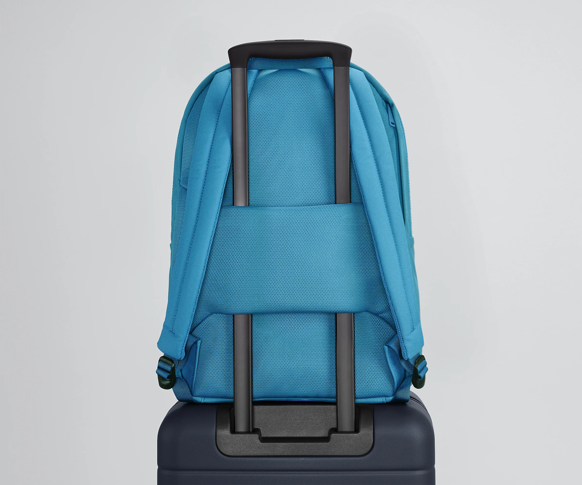 Active Backpack 26L secured to an Away suitcase