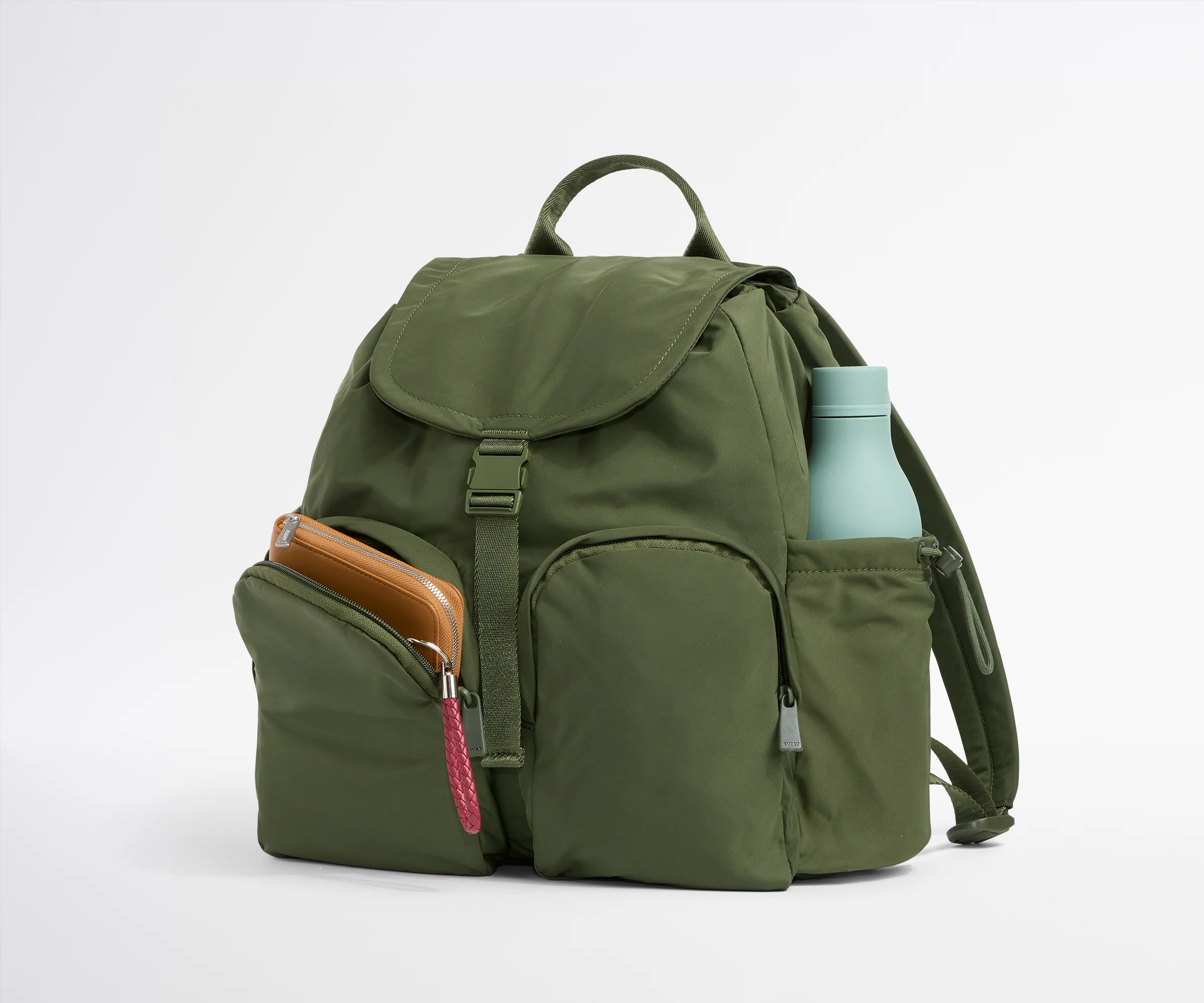 Green backpack with a water bottle on a white background