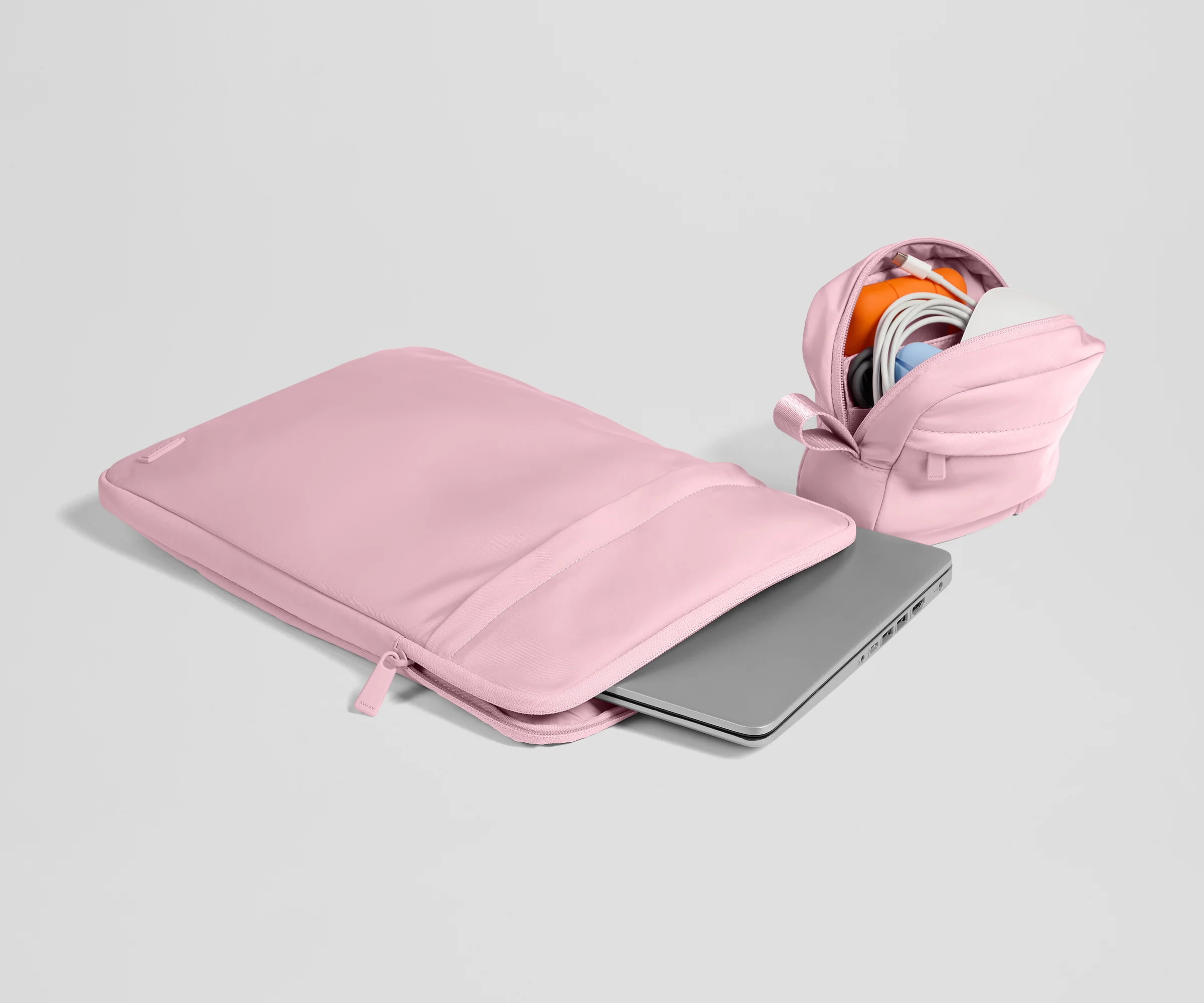 Pink laptop sleeve with a partially open view on a light gray background