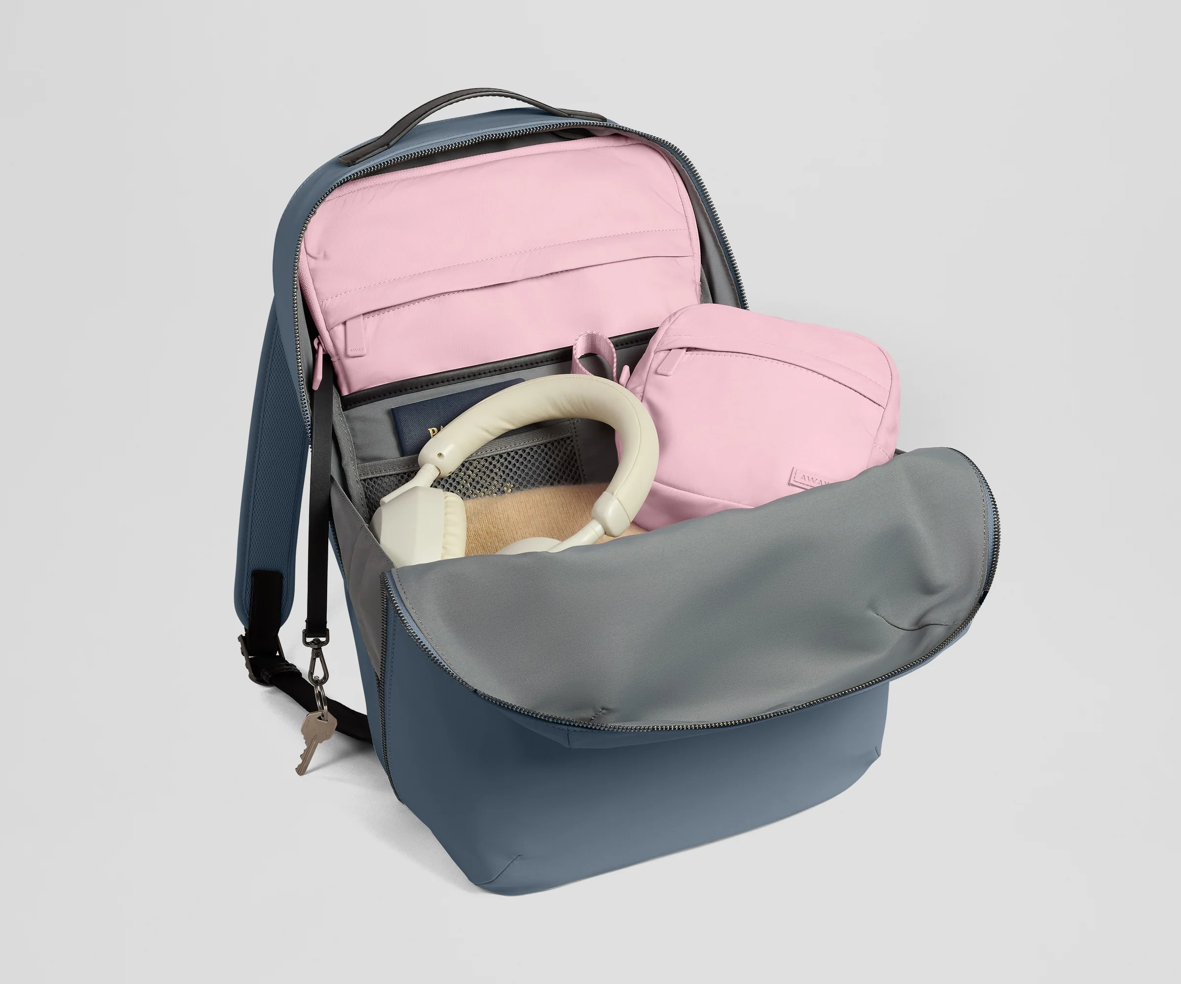 Open backpack with a pink laptop sleeve and tech case