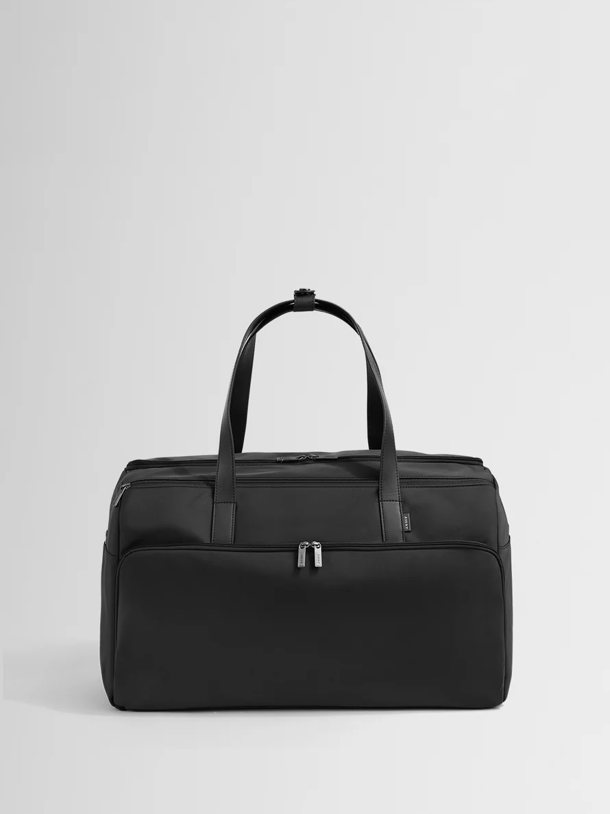 Front view of the Garment Duffle Bag in Jet Black with upright leather handles