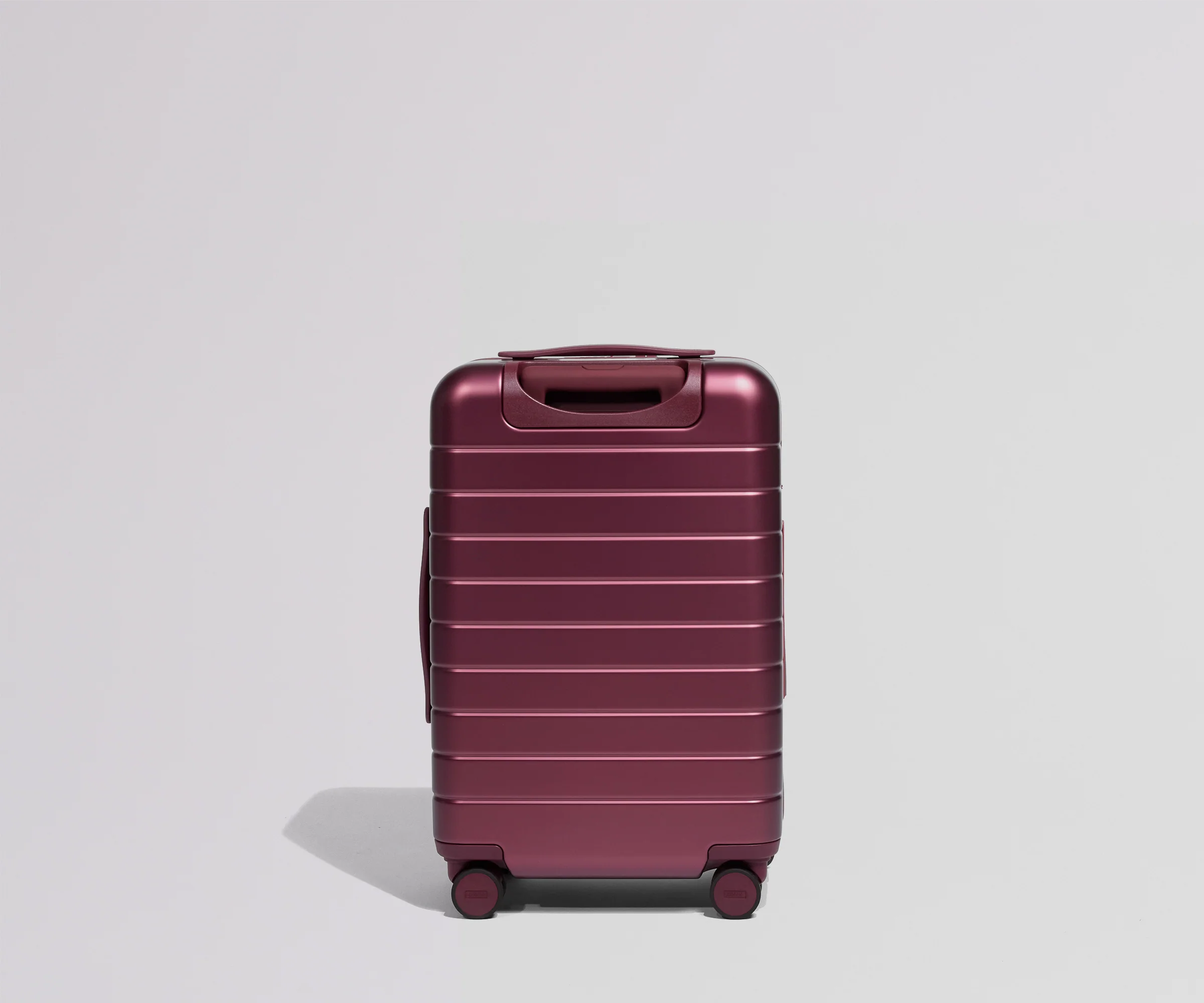 Maroon suitcase on a light gray background