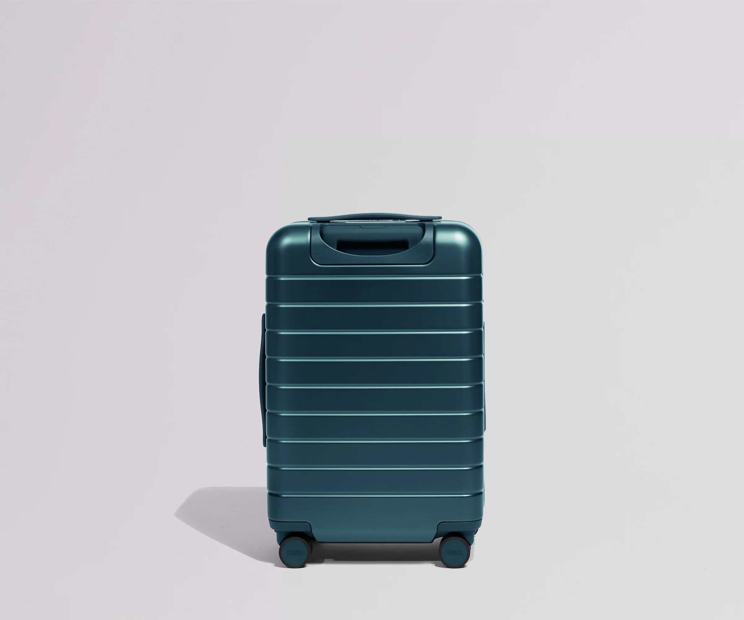 Teal suitcase on a light gray background