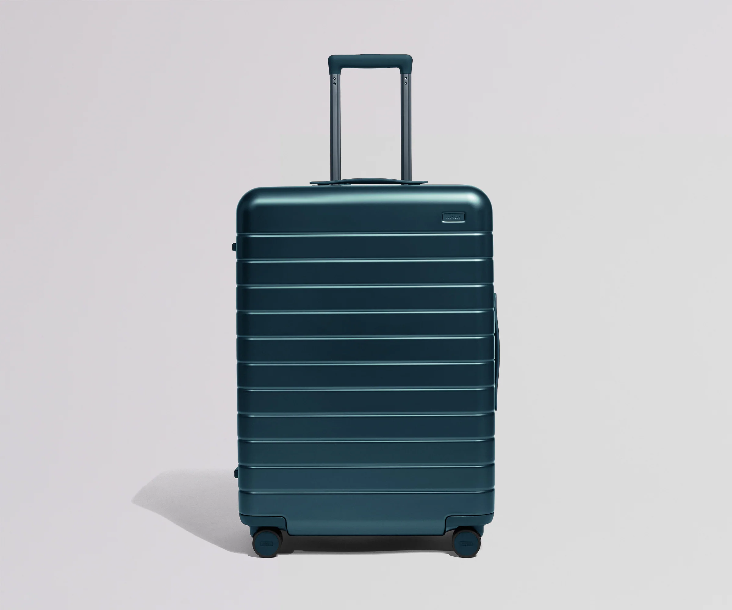 Teal suitcase on a light gray background