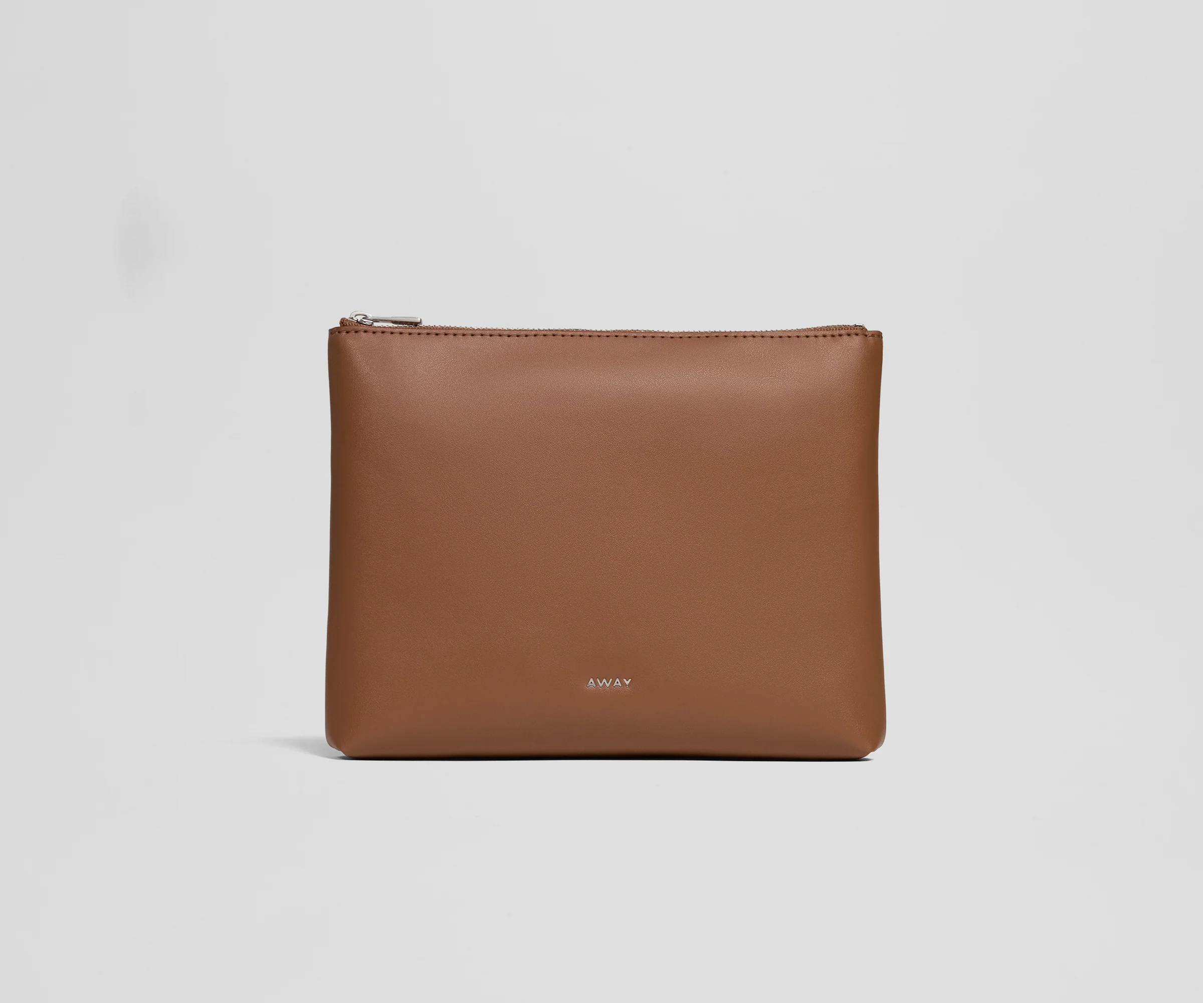 Brown leather pouch with 'AWAY' branding on a light gray background