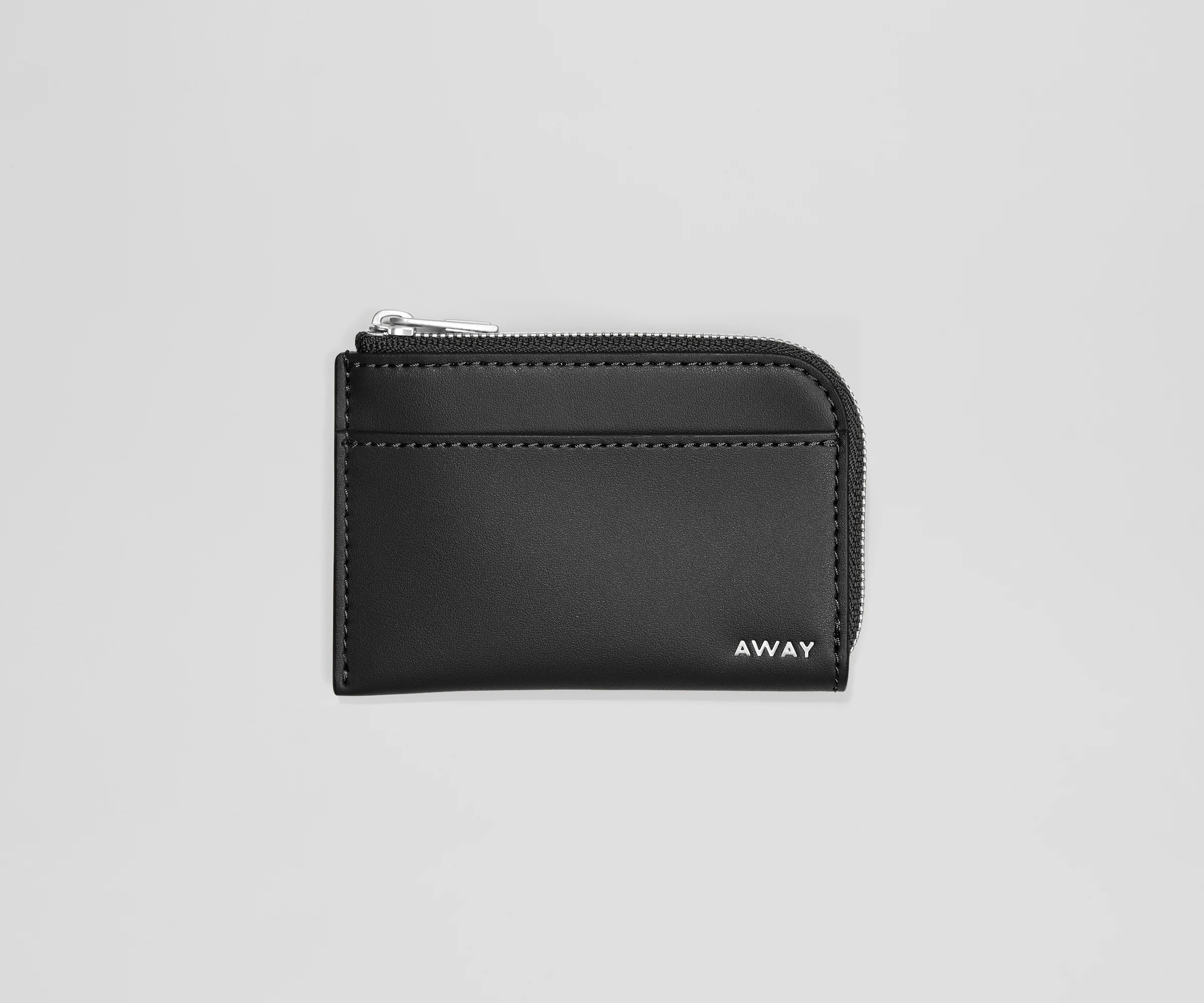 Black wallet with 'AWAY' branding on a light gray background