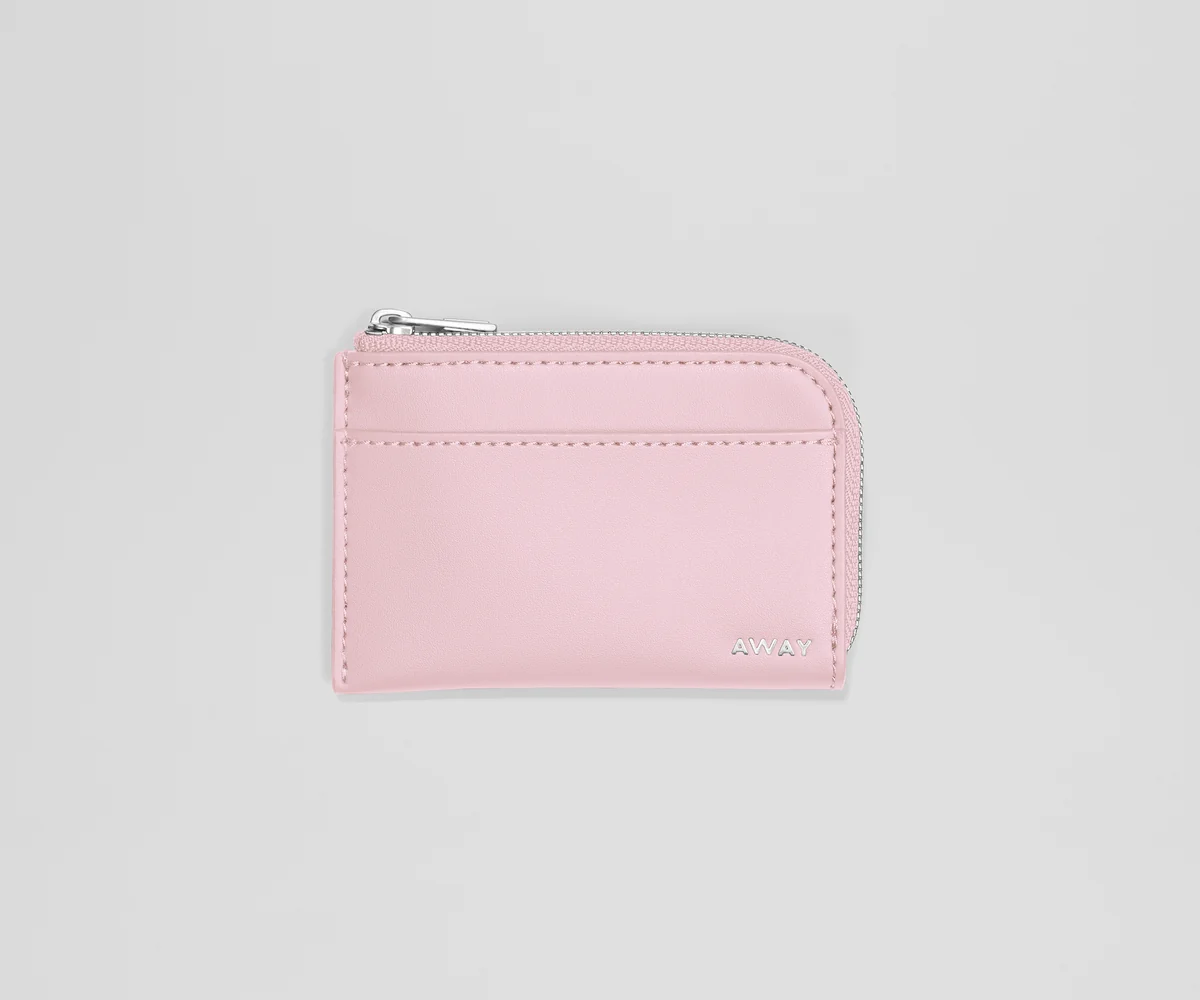 Pink wallet with a zipper on a light gray background