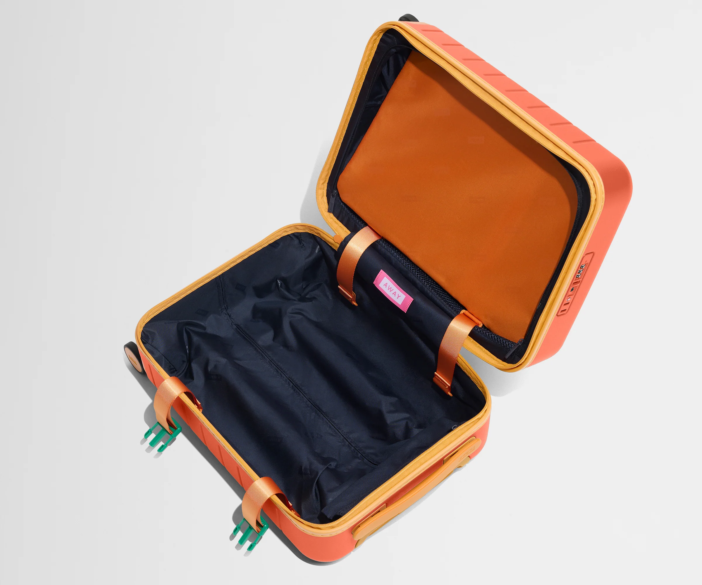 The Kids Carry-On suitcase in Poppy Orange shown open and empty on its side to show capacity