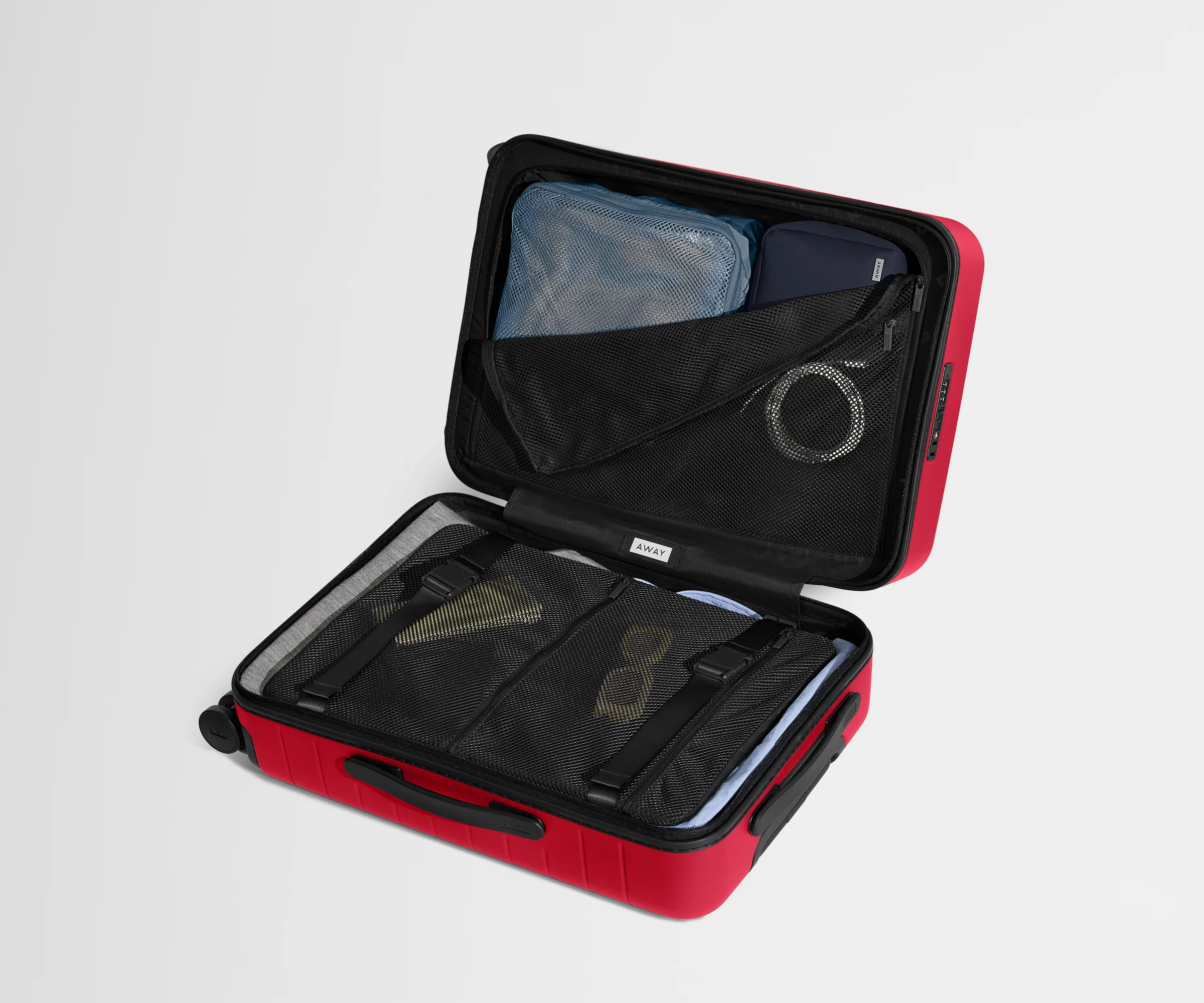 Red suitcase with black interior compartments on a light gray background