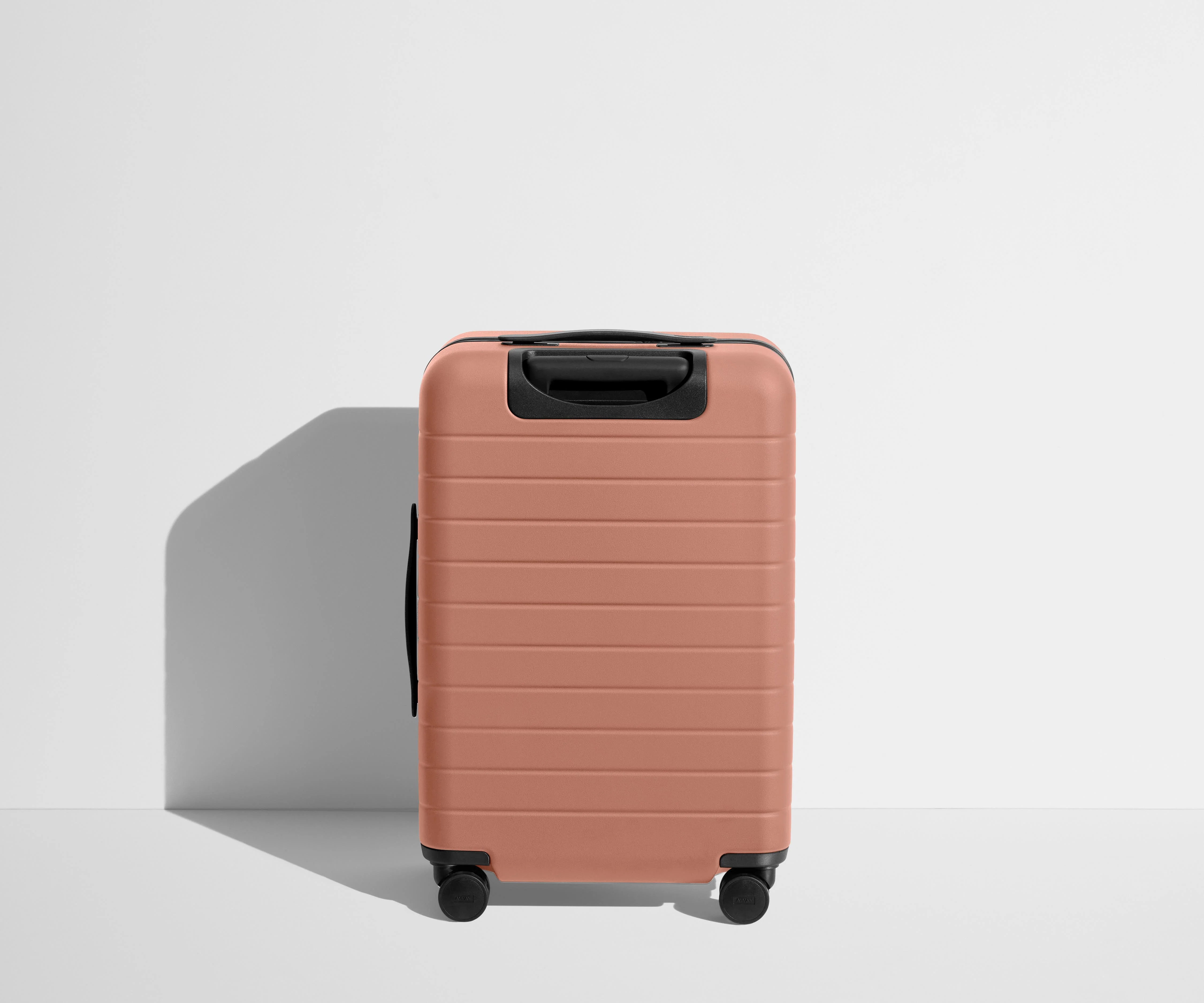 Back product view of The Carry-On suitcase in Clay Pink