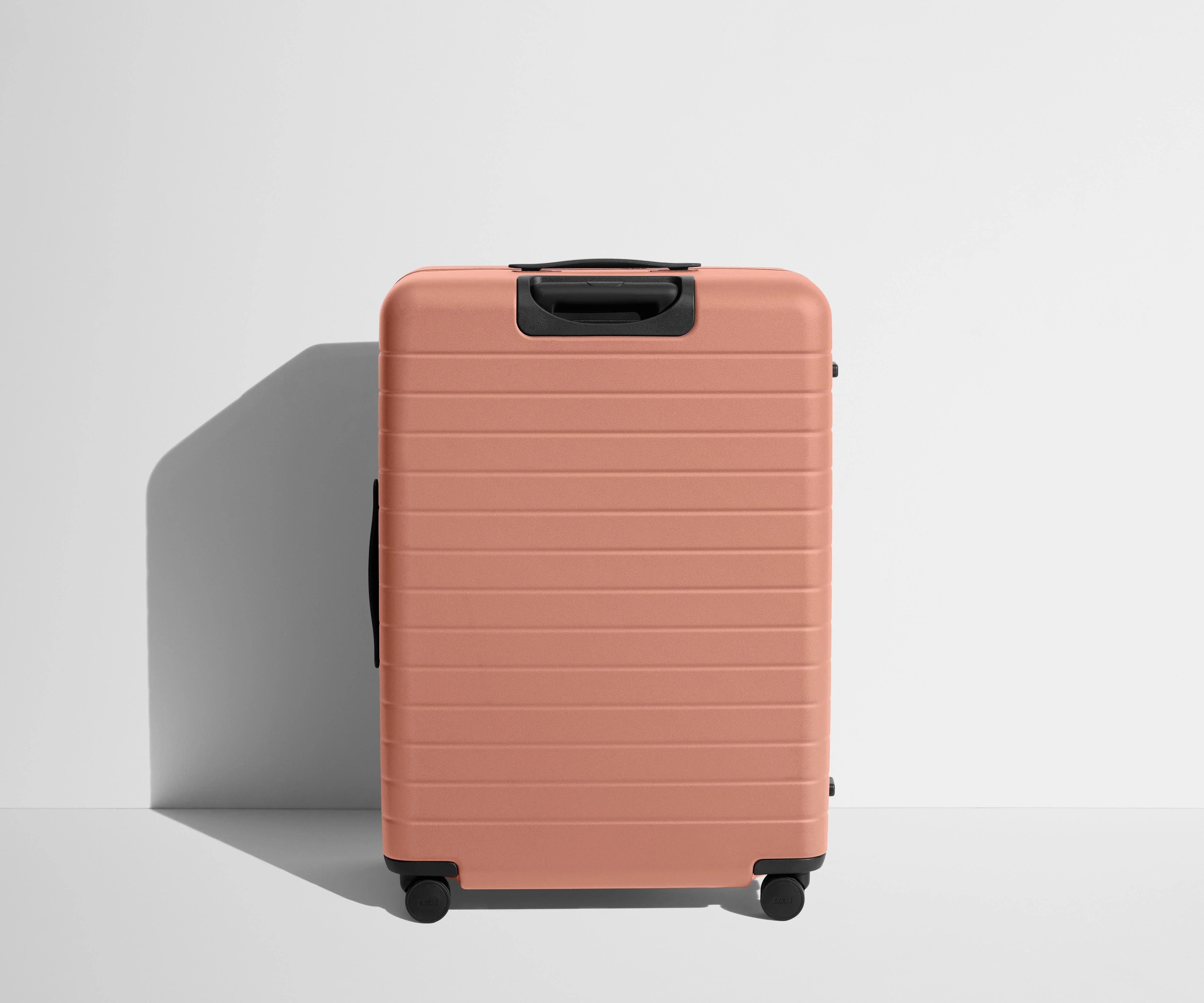 Back product view of The Large Flex suitcase in Clay Pink