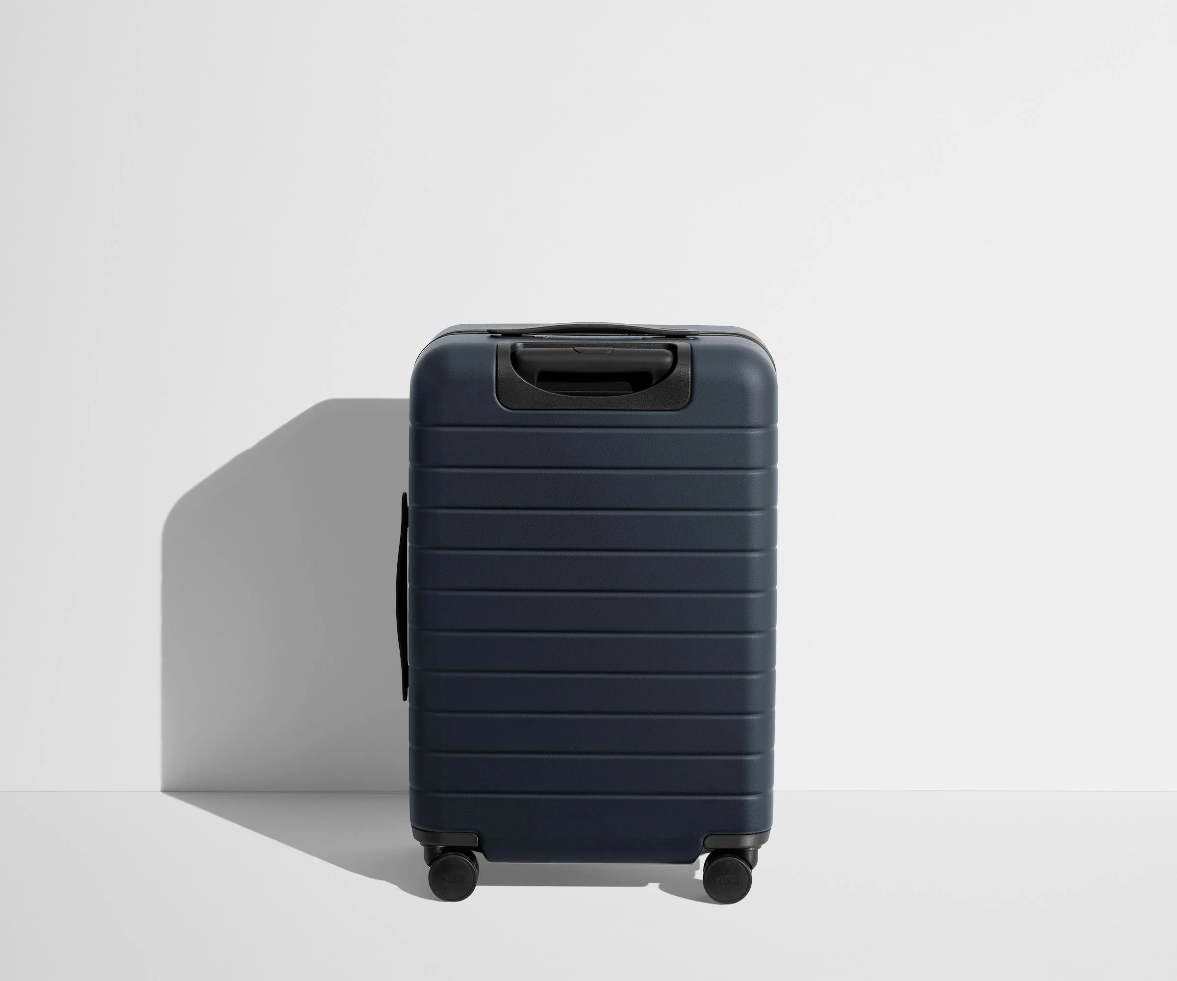 Back product view of The Bigger Carry-On Flex suitcase in Navy Blue