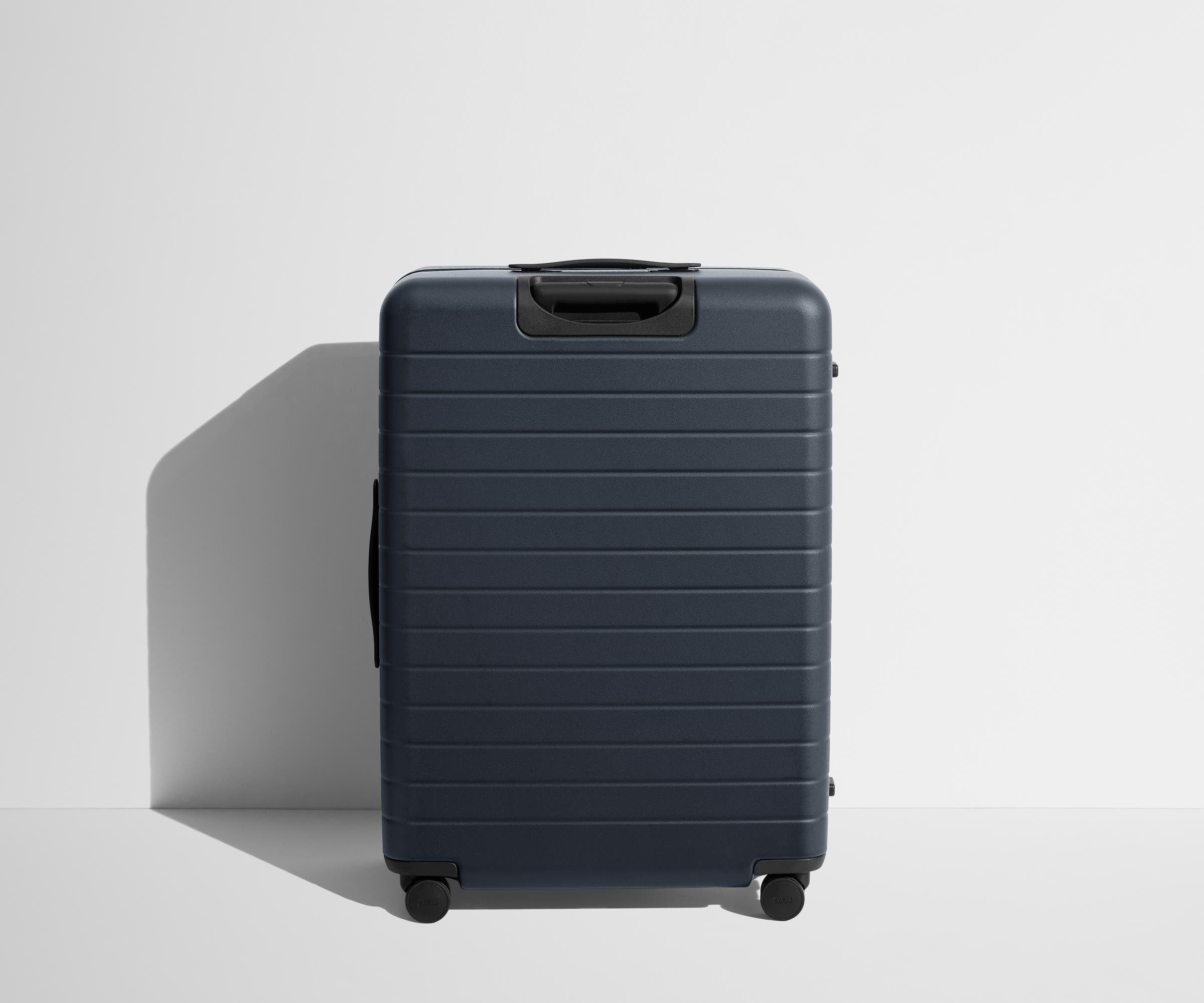Back product view of The Large Flex suitcase in Navy Blue