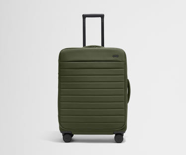 Front product view of The Softside Medium suitcase in Olive Green with raised handle