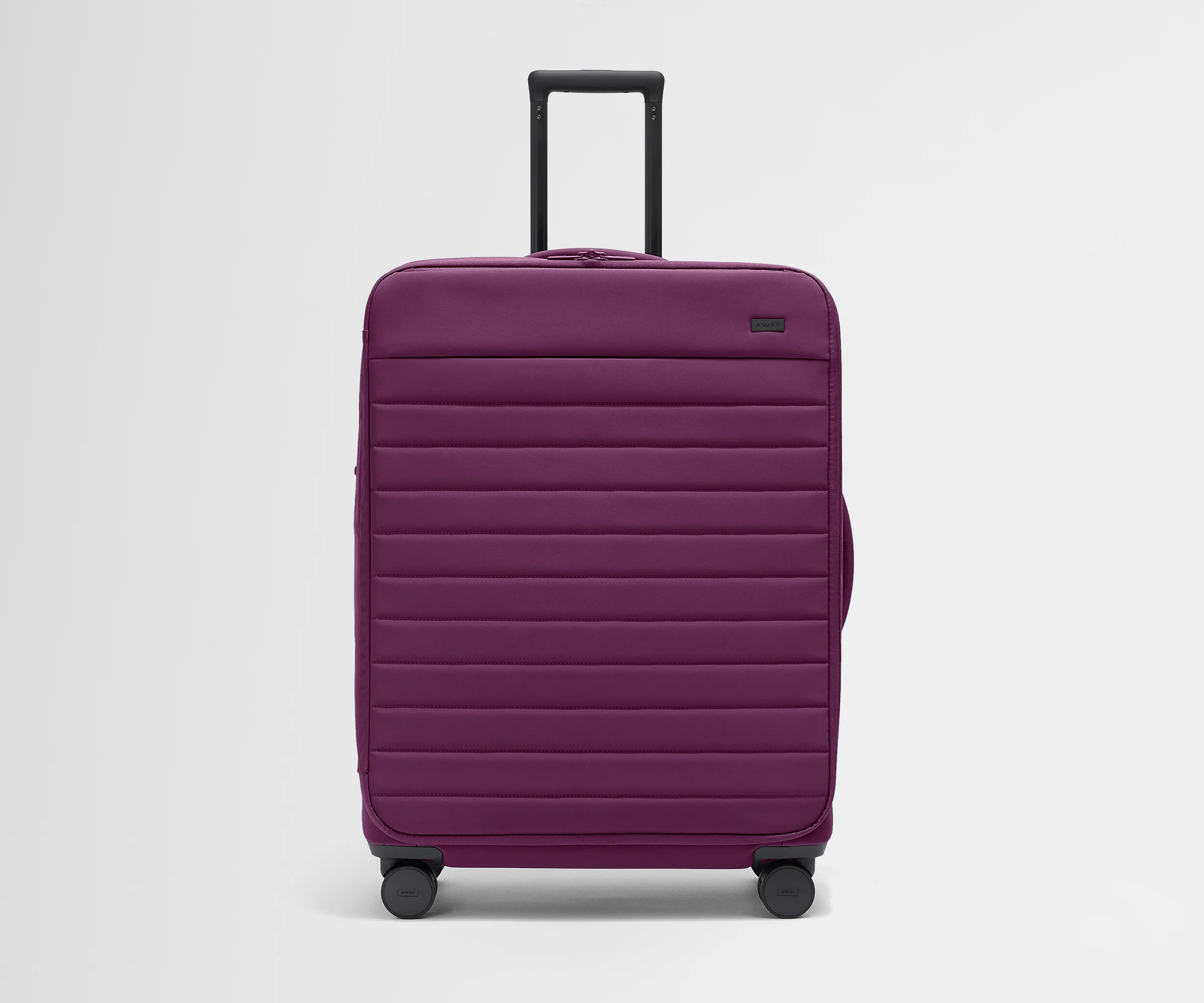 Front product view of The Softside Large suitcase in Plum Purple with raised handle