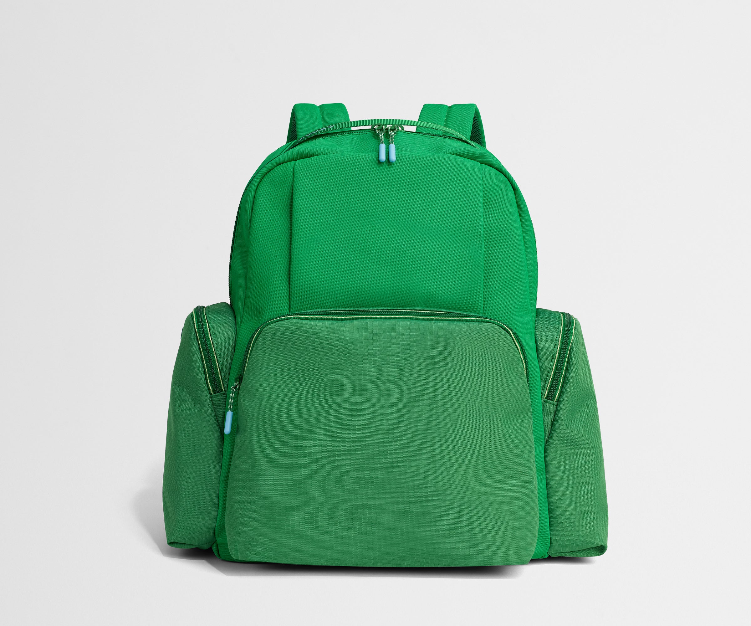 Green backpack on a light gray background