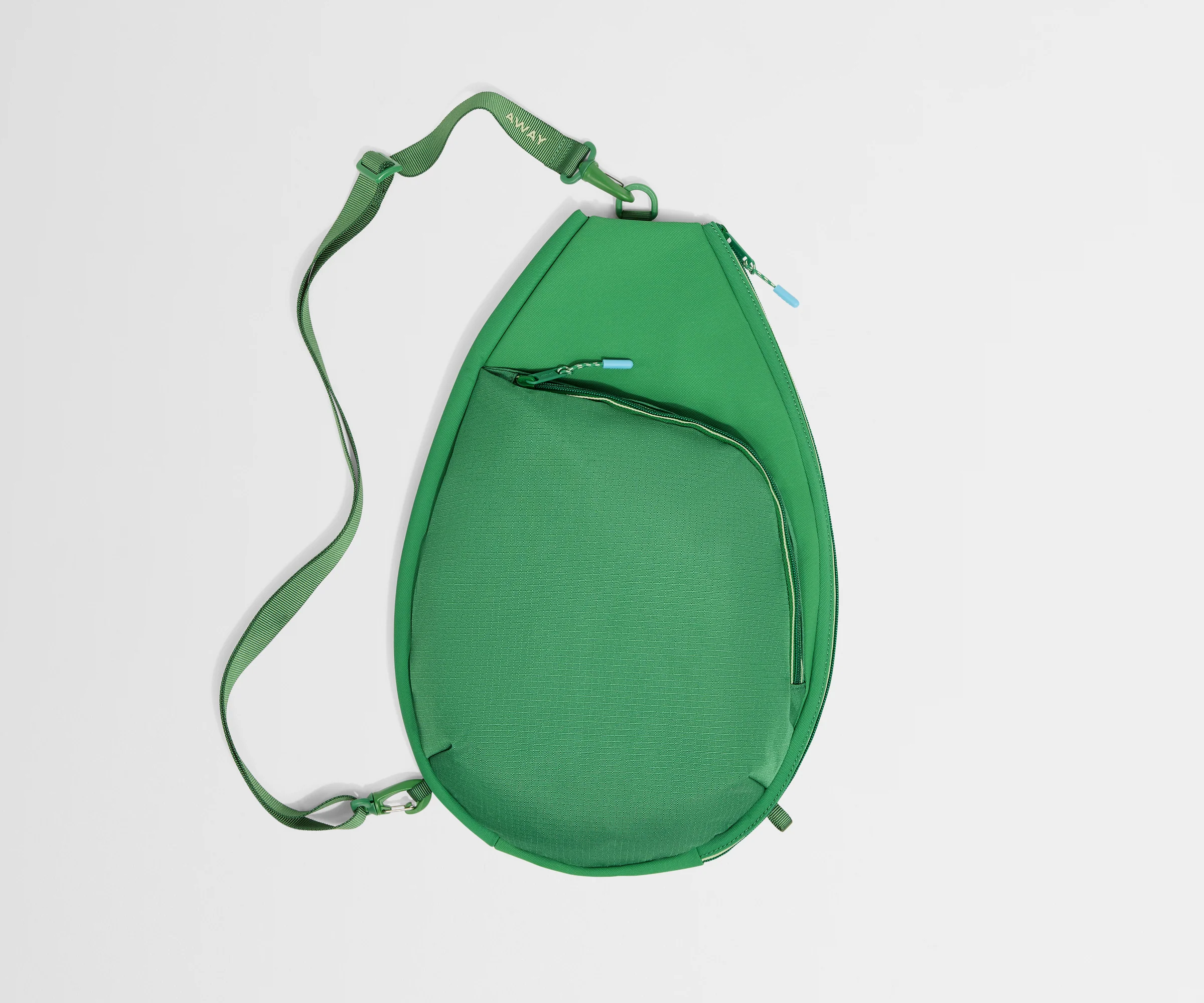 Green crossbody bag on a light gray background