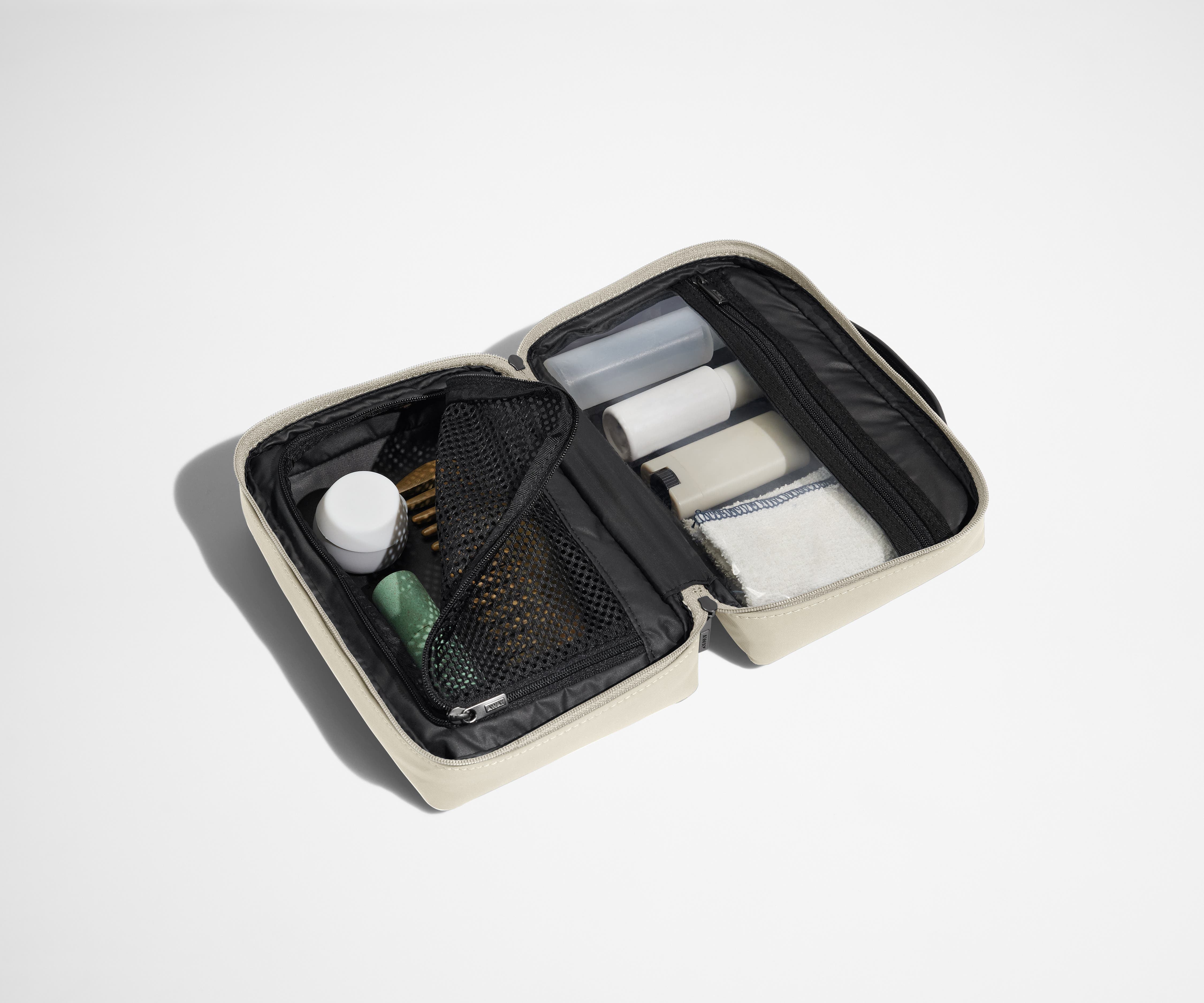 Small Toiletry Bag packed with a comb, skincare, and other travel-sized toiletries