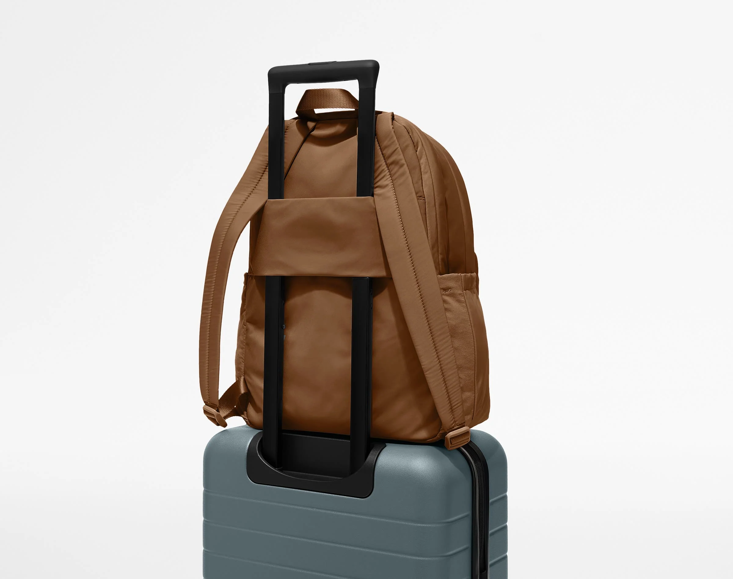 Large Featherlight Backpack on top of an Away suitcase
