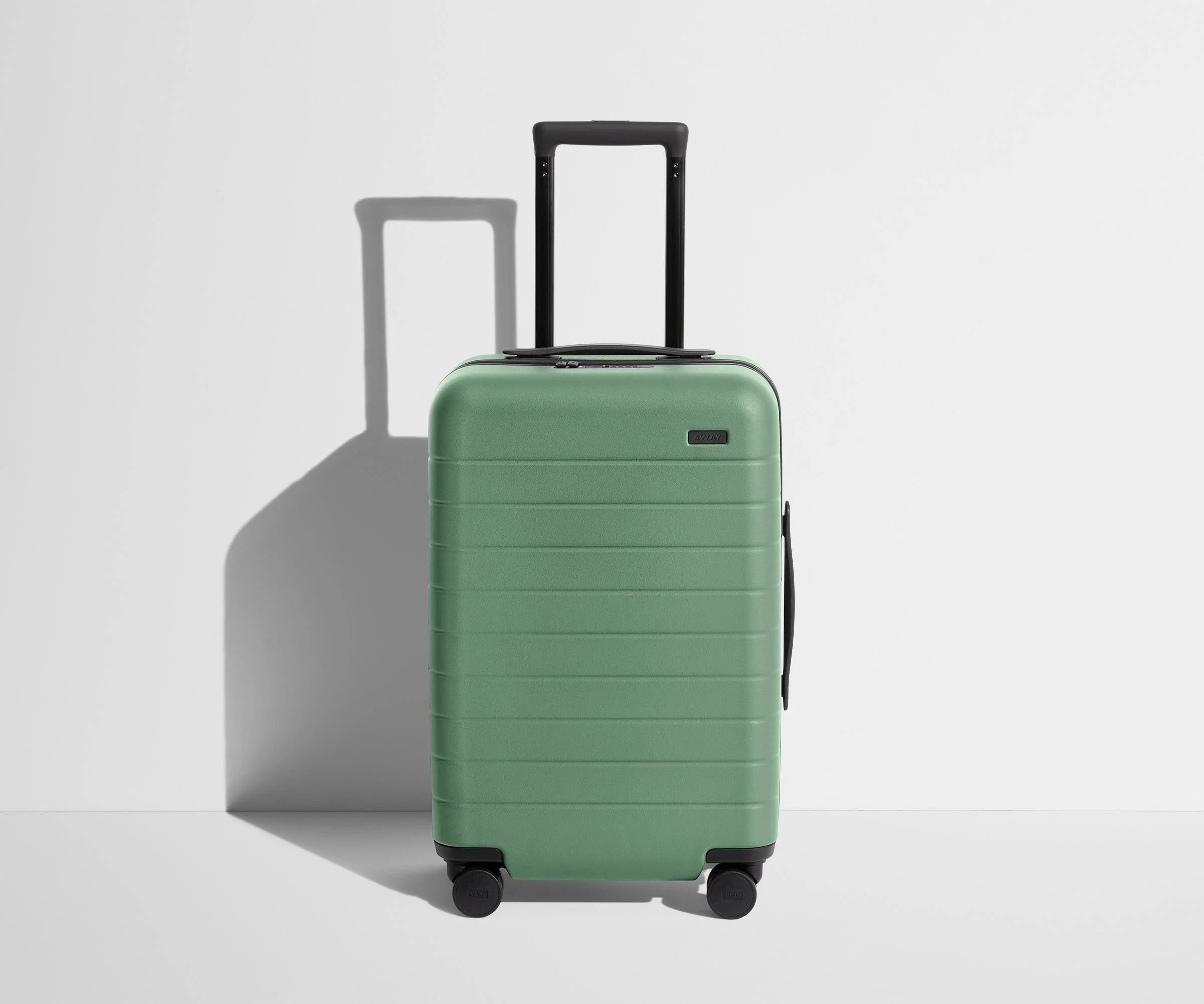 Front product view of The Carry-On suitcase in Sea Green with raised handle