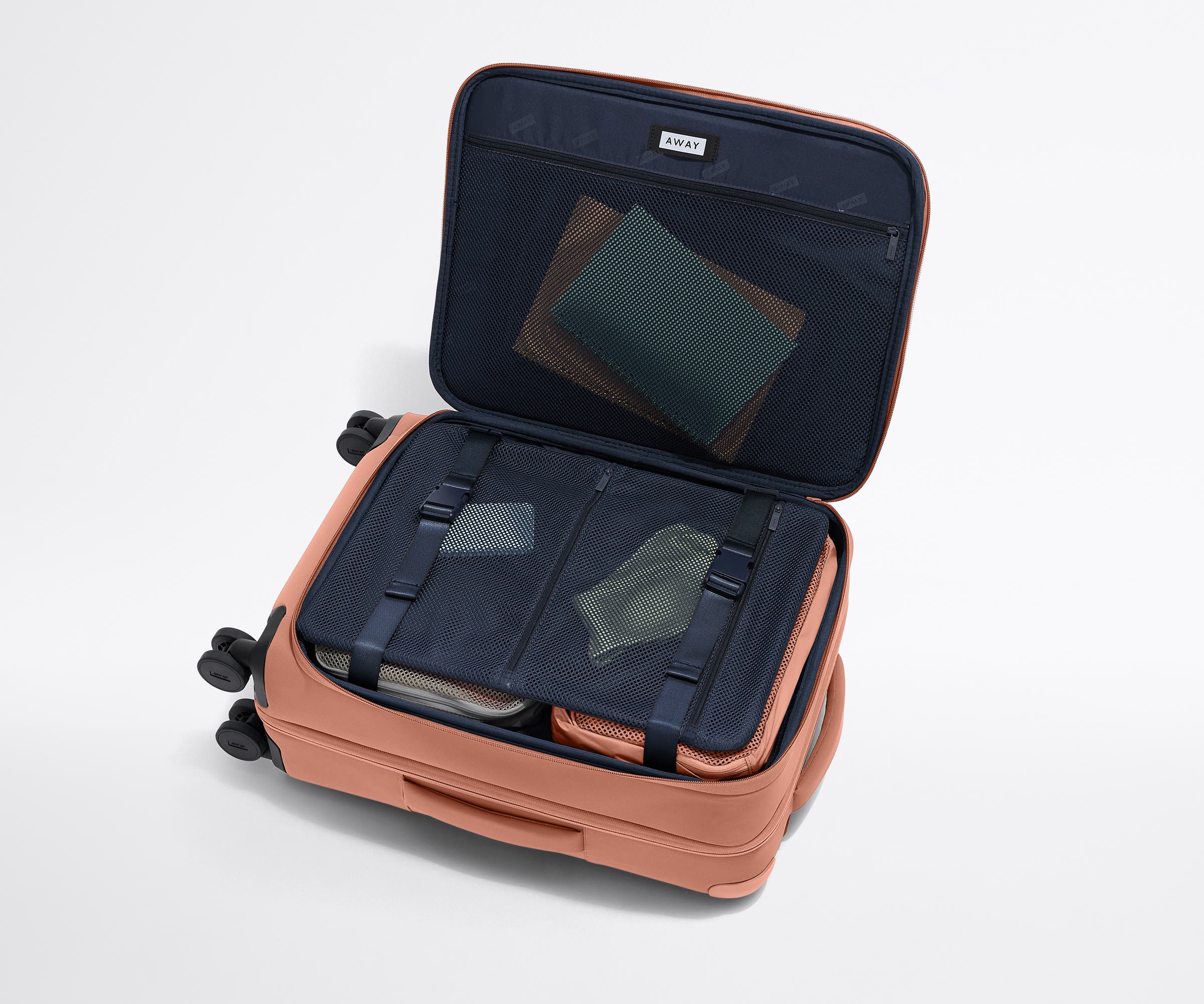 Open Softside Bigger Carry-On suitcase, with travel essentials in the front flap pocket and compression pad pockets
