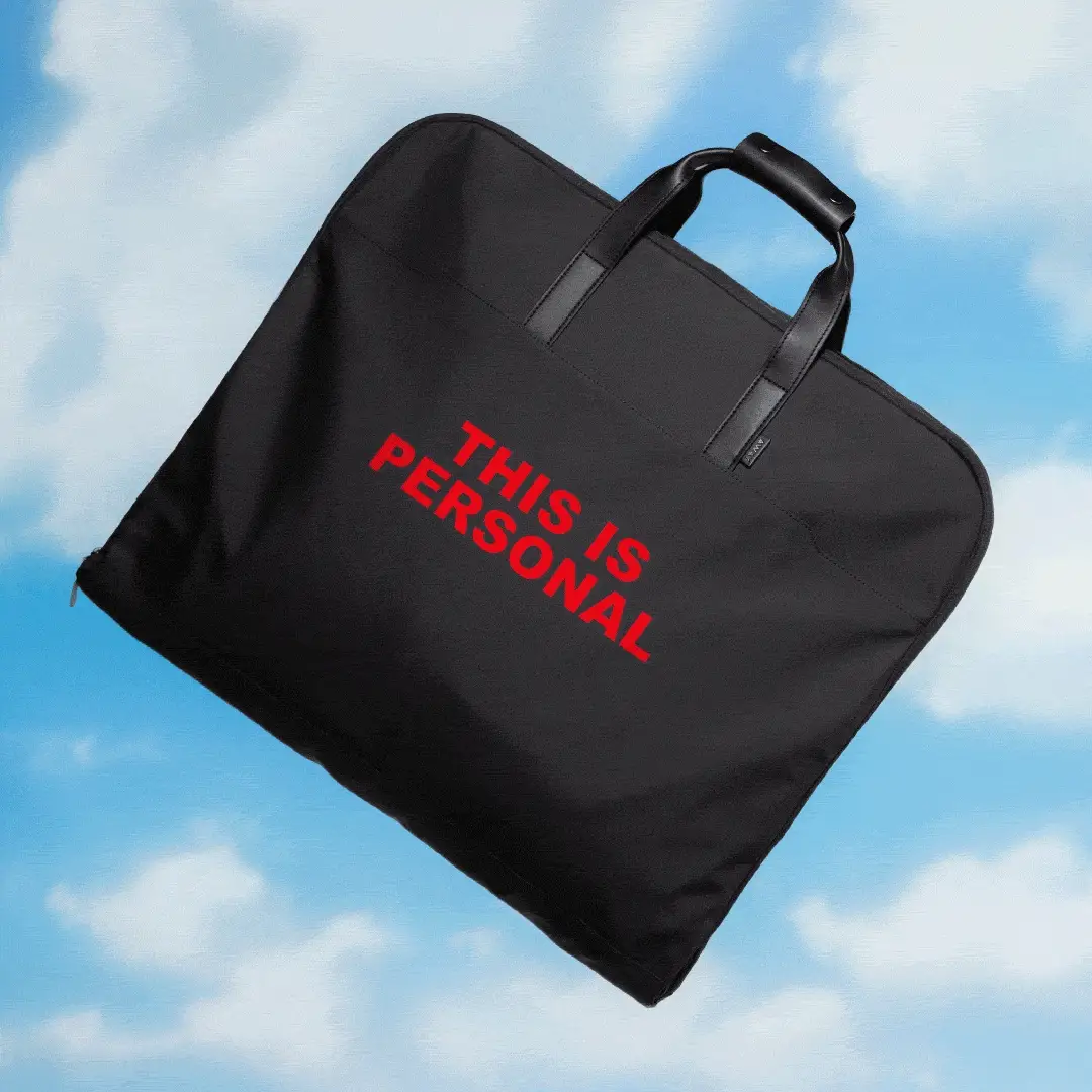 A black Away Garment bag with the text 